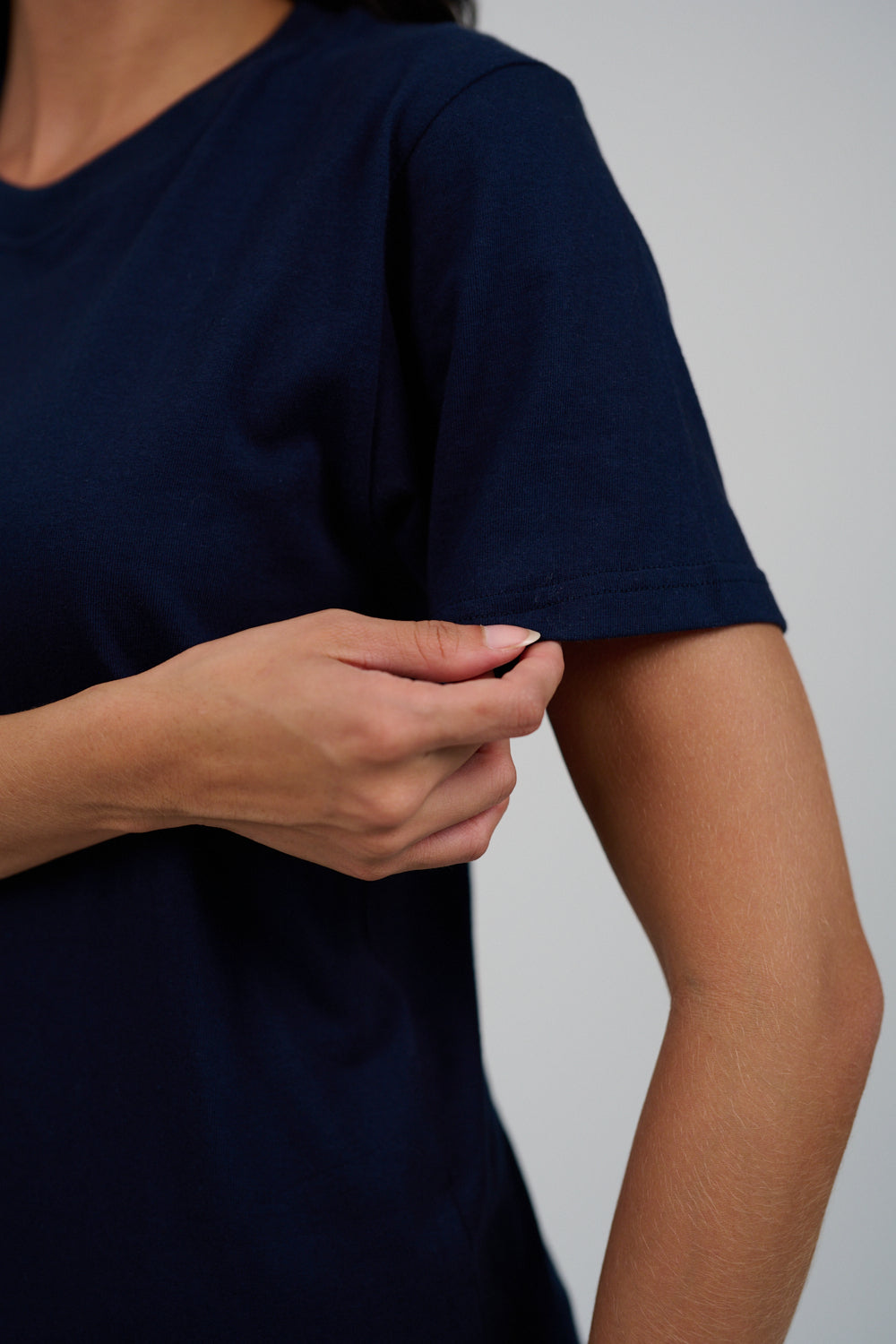 Person wearing a navy blue t-shirt against a plain background