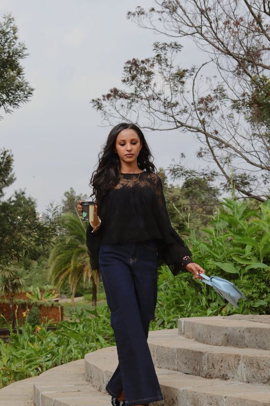 women wearing ENKU Jeans holding coffee and walking in the park