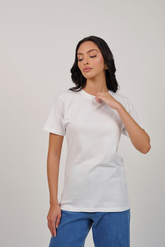 Woman wearing a plain white t-shirt against a light gray background